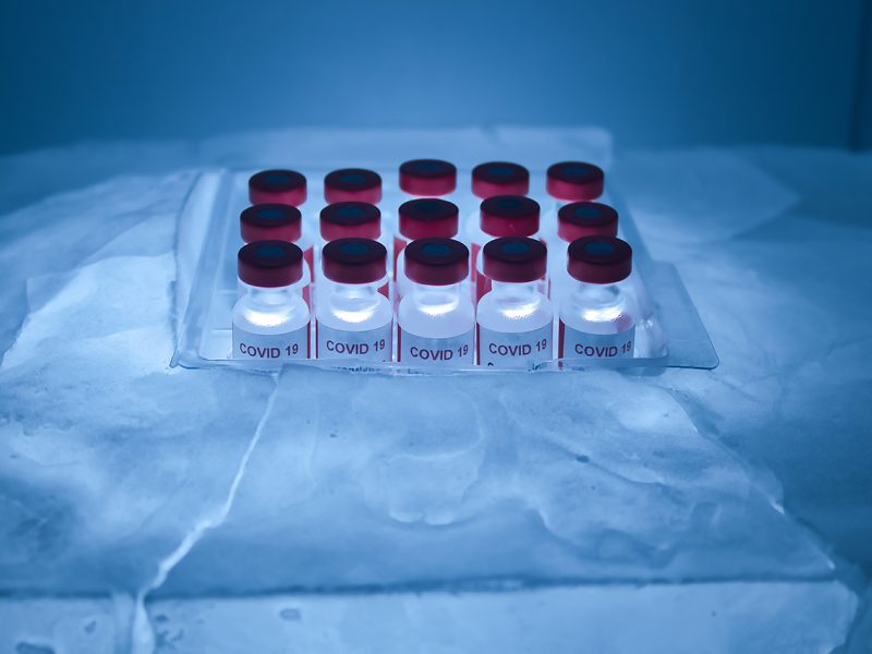 Group of vaccines for Covid 19 virus in a block of ice for preservation and transport.